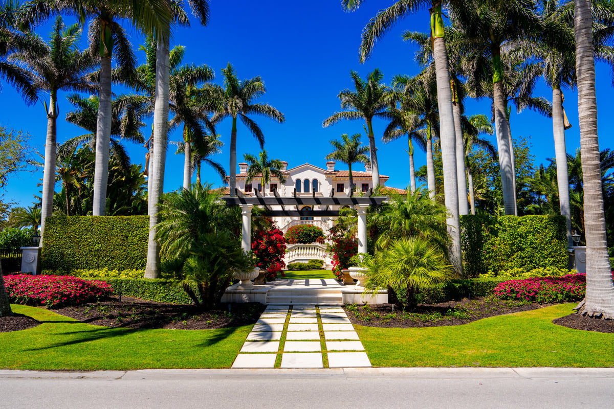 Luxury waterfront mansion at sunset