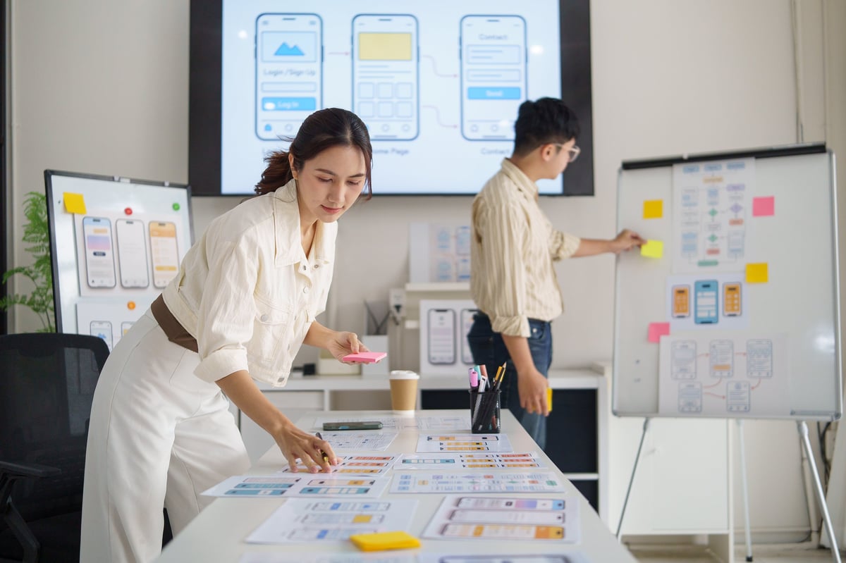 UX designer planning mobile app interface and wireframe layouts