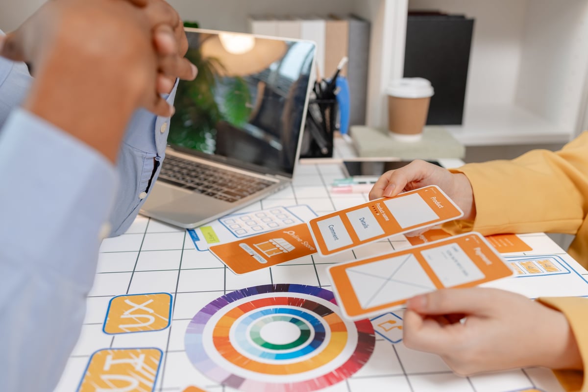 UX designer presenting wireframes and mobile app concepts during a collaborative design workshop